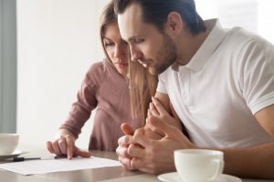 Couple looking at home purchasing paperwork