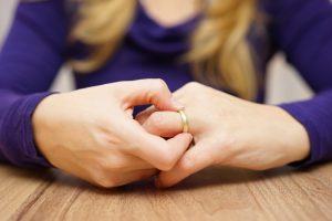 Woman taking off wedding ring