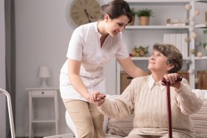 A nurse helping a senior woman