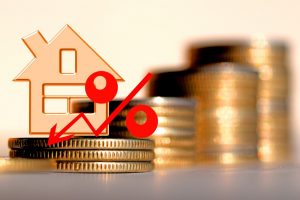 red percent on a background of money & house - the concept of changing prices in the market