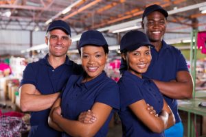 happy textile factory co-workers with arms crossed