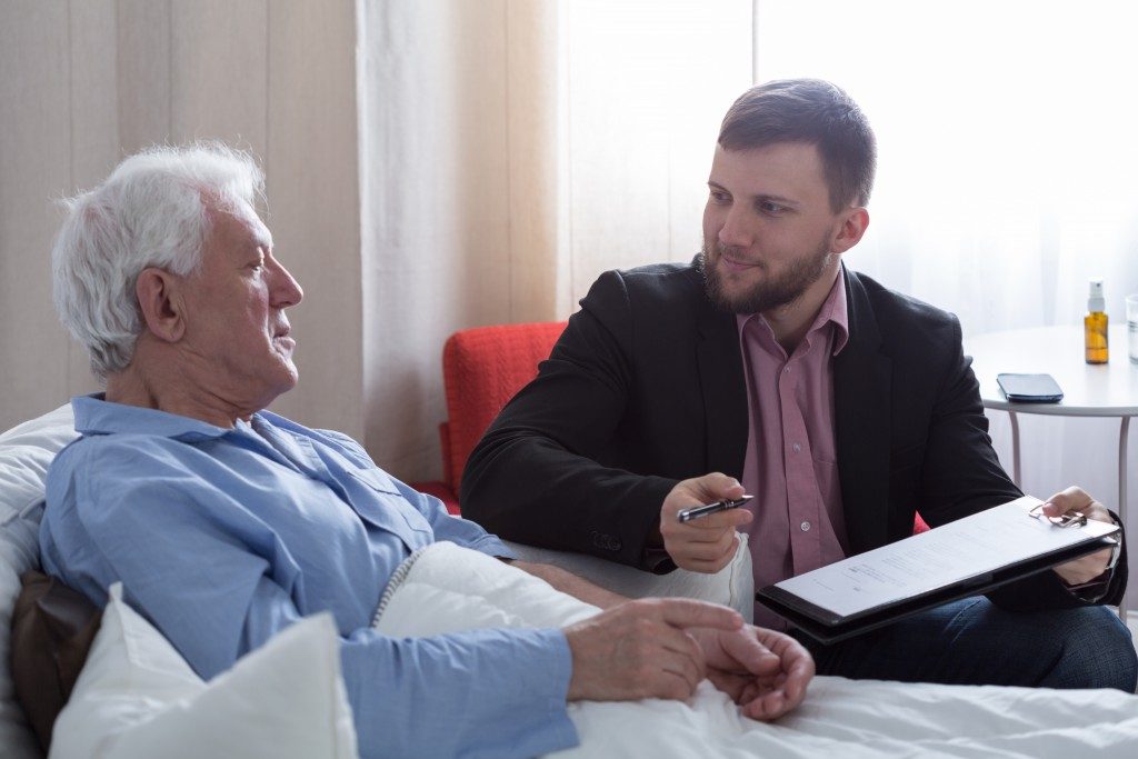 lawyer taking the will of an elderly man
