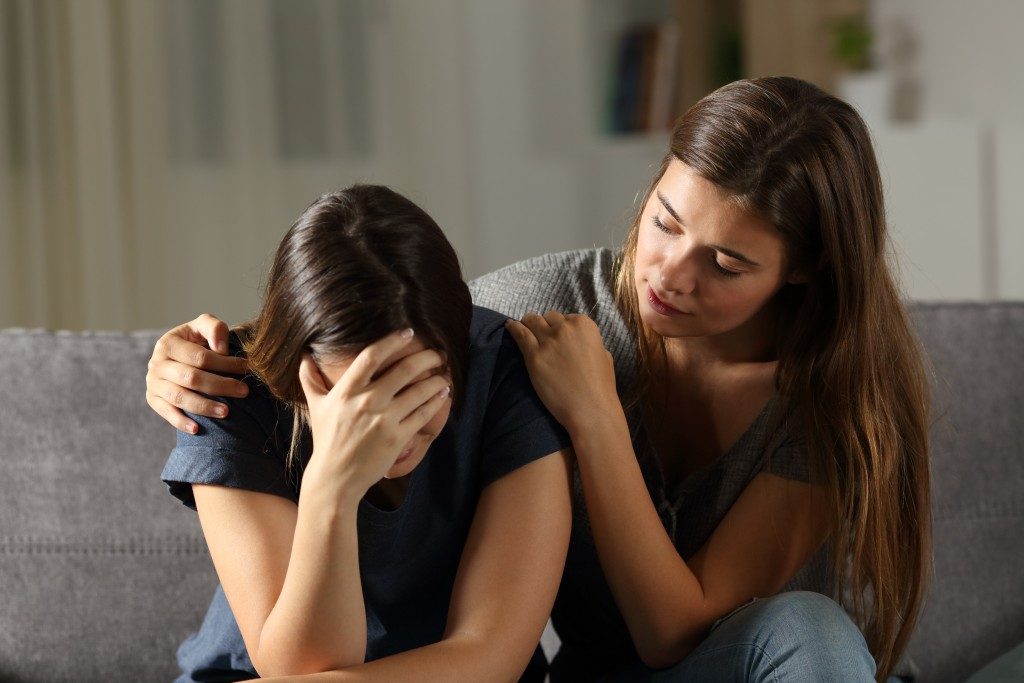 Woman being comforted